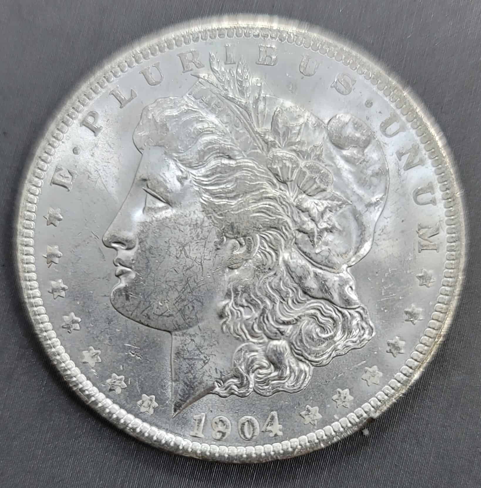 1904 Morgan silver dollar — gold coins and silver coins pay as coins, not only melt