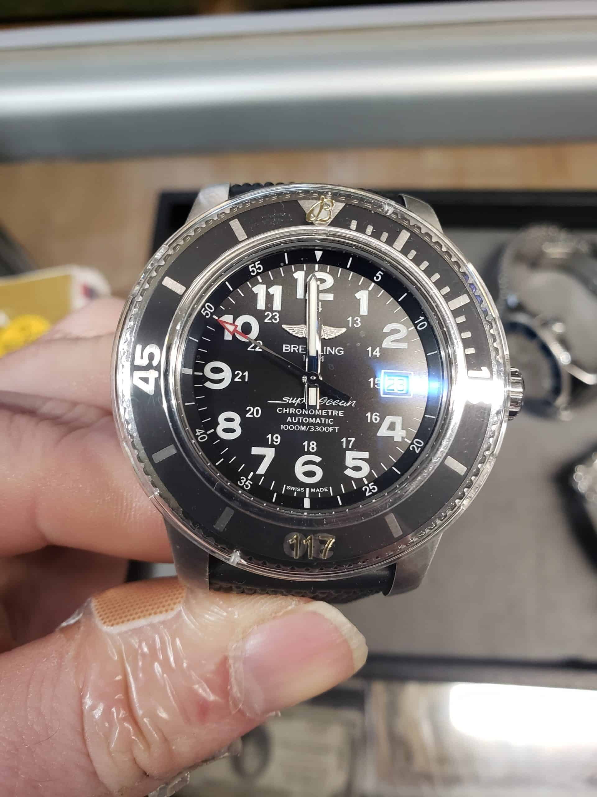 Breitling SuperOcean 1000m dive watch with black dial and white Arabic numerals, photographed at Apex Gold Silver Coins