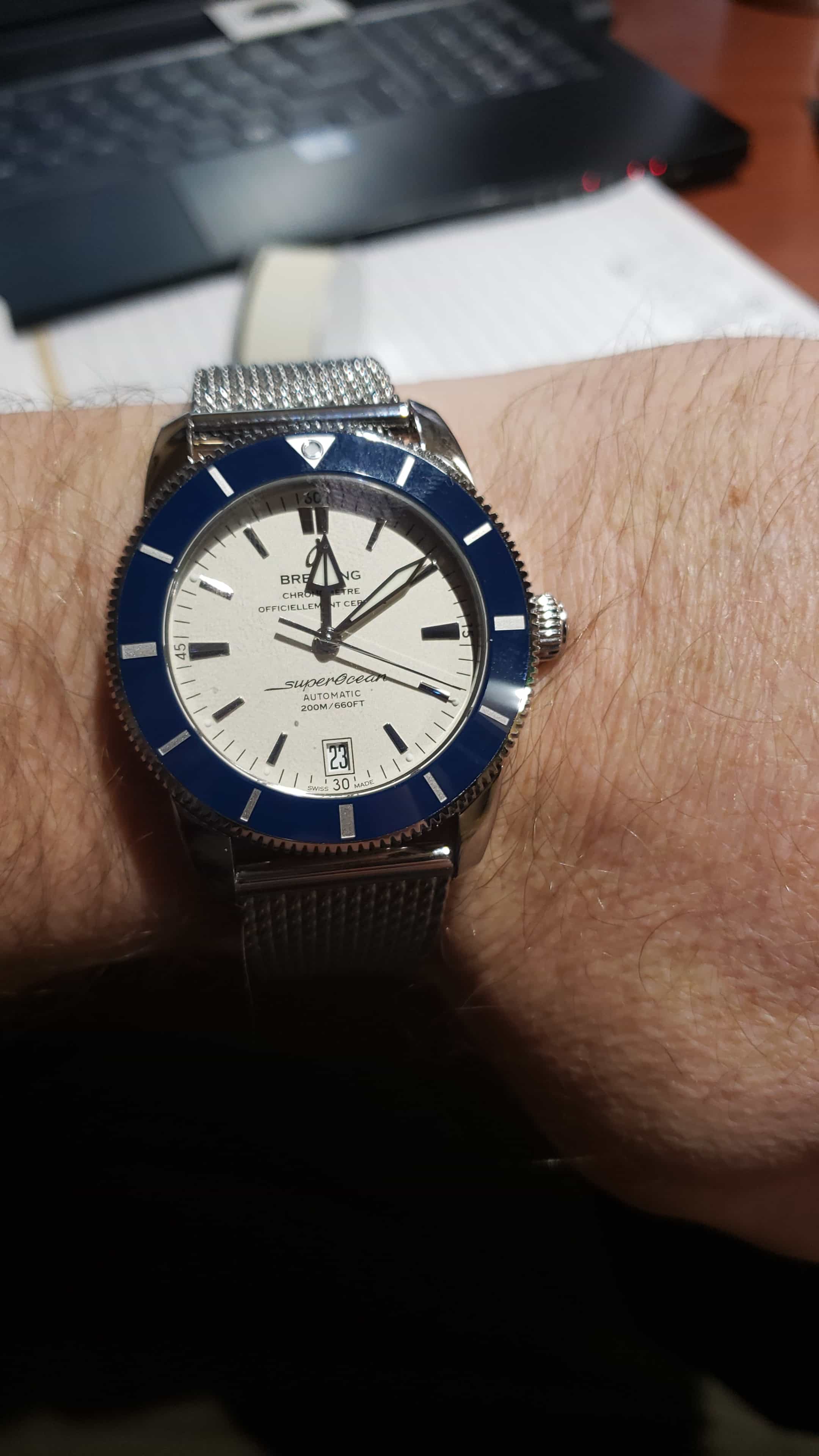 Breitling Superocean Heritage watch with white dial, blue bezel and mesh bracelet